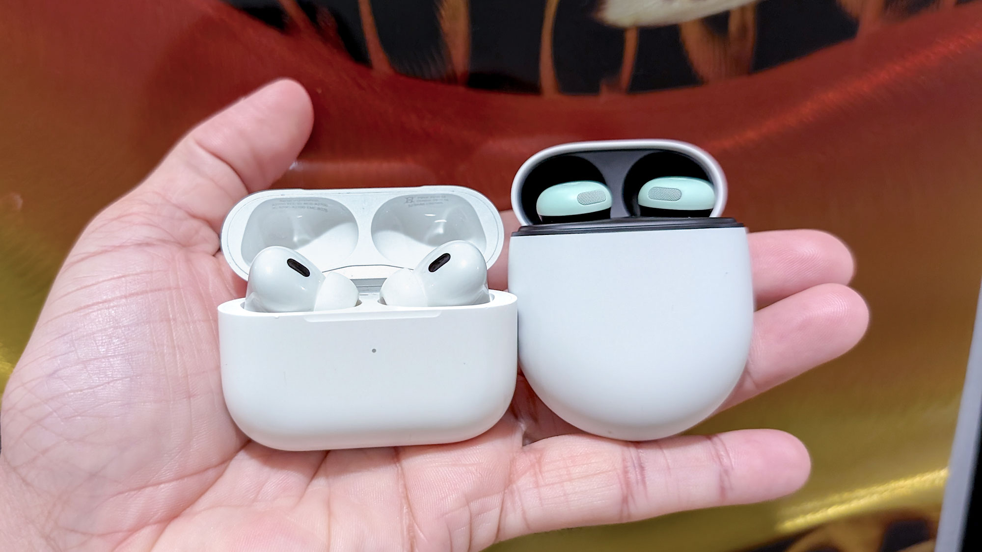 The AirPods Pro 2 vs. Google Pixel Buds Pro 2 next to one another.