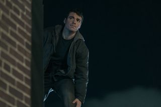 Peter stands atop a building in The Night Agent season 2