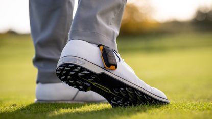 Golfer's shoe during a shot wearing the BAL.ON device