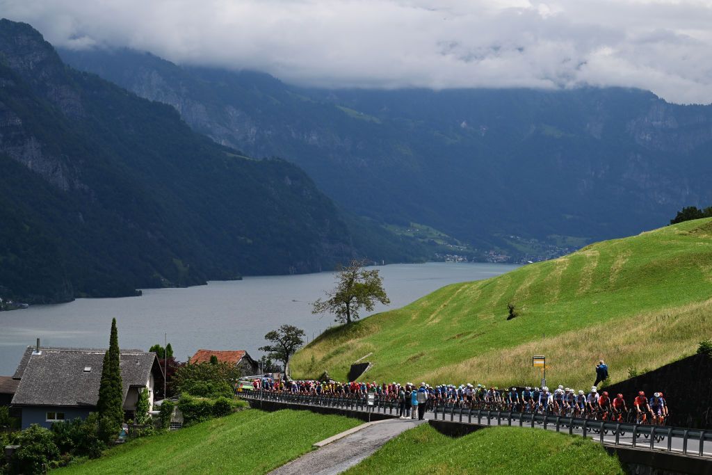 REGENSDORF SWITZERLAND JUNE 10 A general view of the peloton compete climbing to the Kerenzerberg 727m passing through Walensee lake during the 87th Tour de Suisse 2024 Stage 2 a 1773km stage from Vaduz to Regensdorf UCIWT on June 10 2024 in Regensdorf Switzerland Photo by Tim de WaeleGetty Images