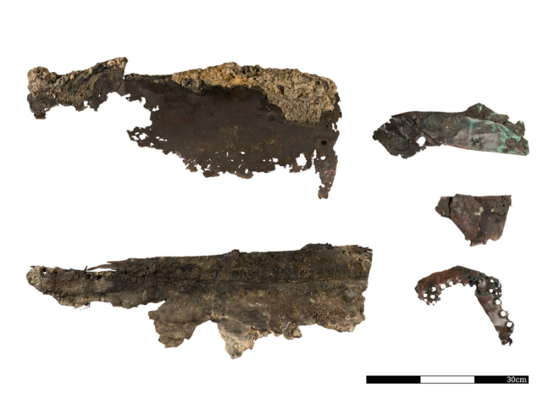 The remains of the shipwreck, the ship's copper plating against a white background