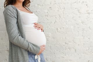 A close-up of a pregnant woman's belly.