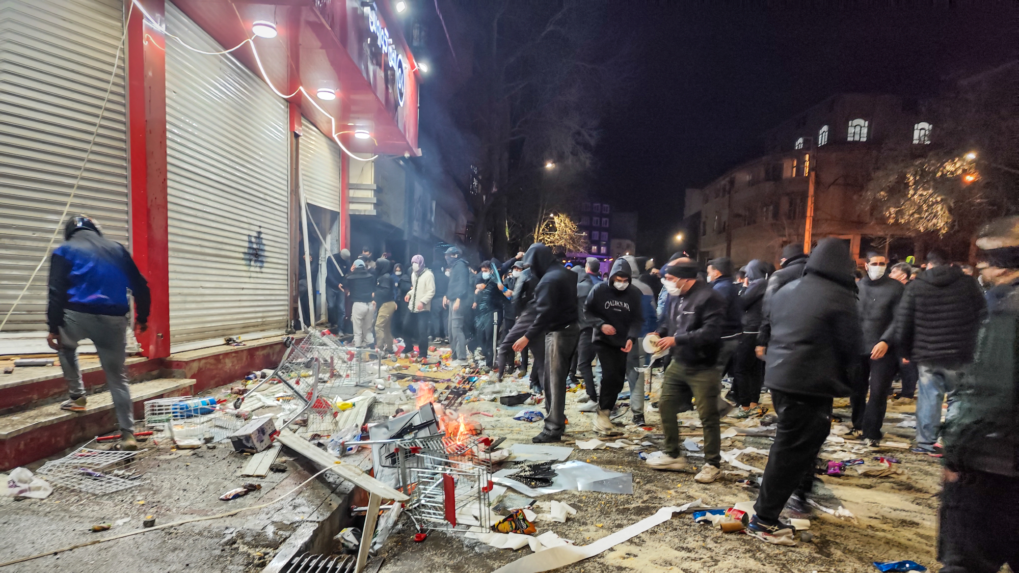 Iranians gather while blocking a street during a protest in Kermanshah, Iran