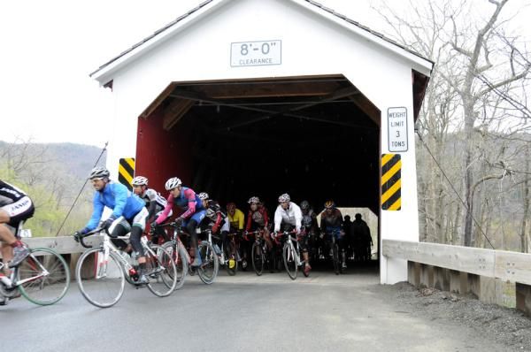The main pack exits the iconic covered bridge at Eagleville