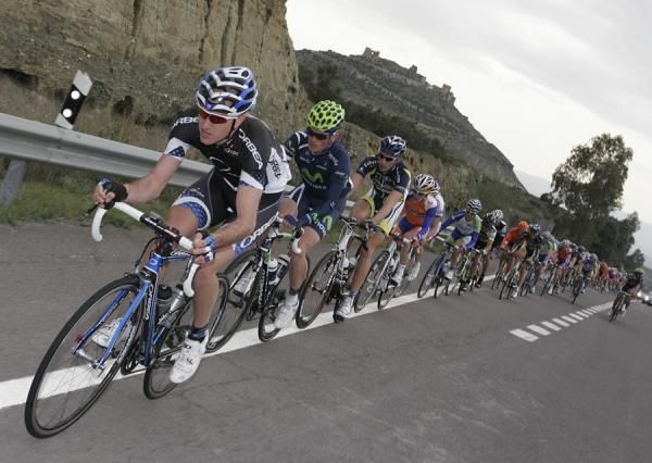 An Orbea Continental rider drives the peloton.