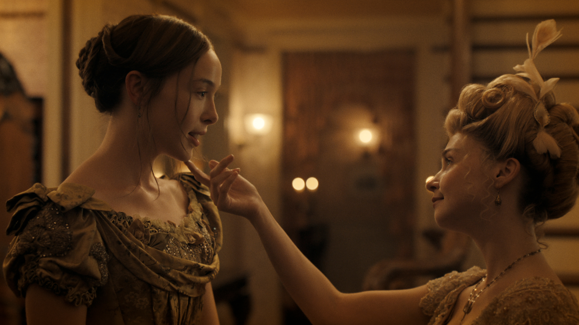 jessica barden as nance o'neil touching ella beatty as lizzie borden's chin in a dimly lit theater in monster the lizzie borden story