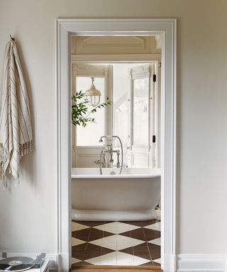 Bathroom painted cream with checker board tile flooring