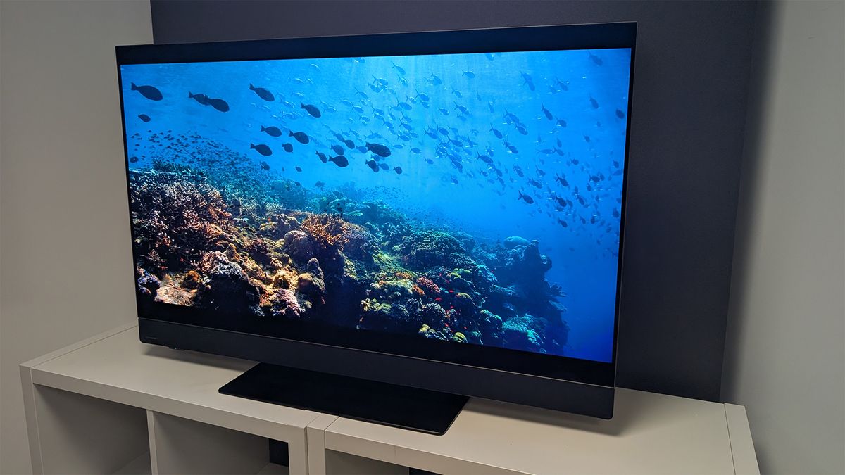 The Panasonic Z90B 48-inch OLED TV on a TV cabinet seen at a slight angle from the right side. On screen is a scene from Netflix's Our Oceans.