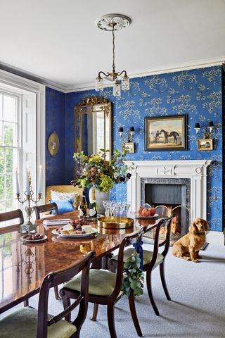 Traditional dining room at New Year with blue and gold wallpaper from Juliet Travers