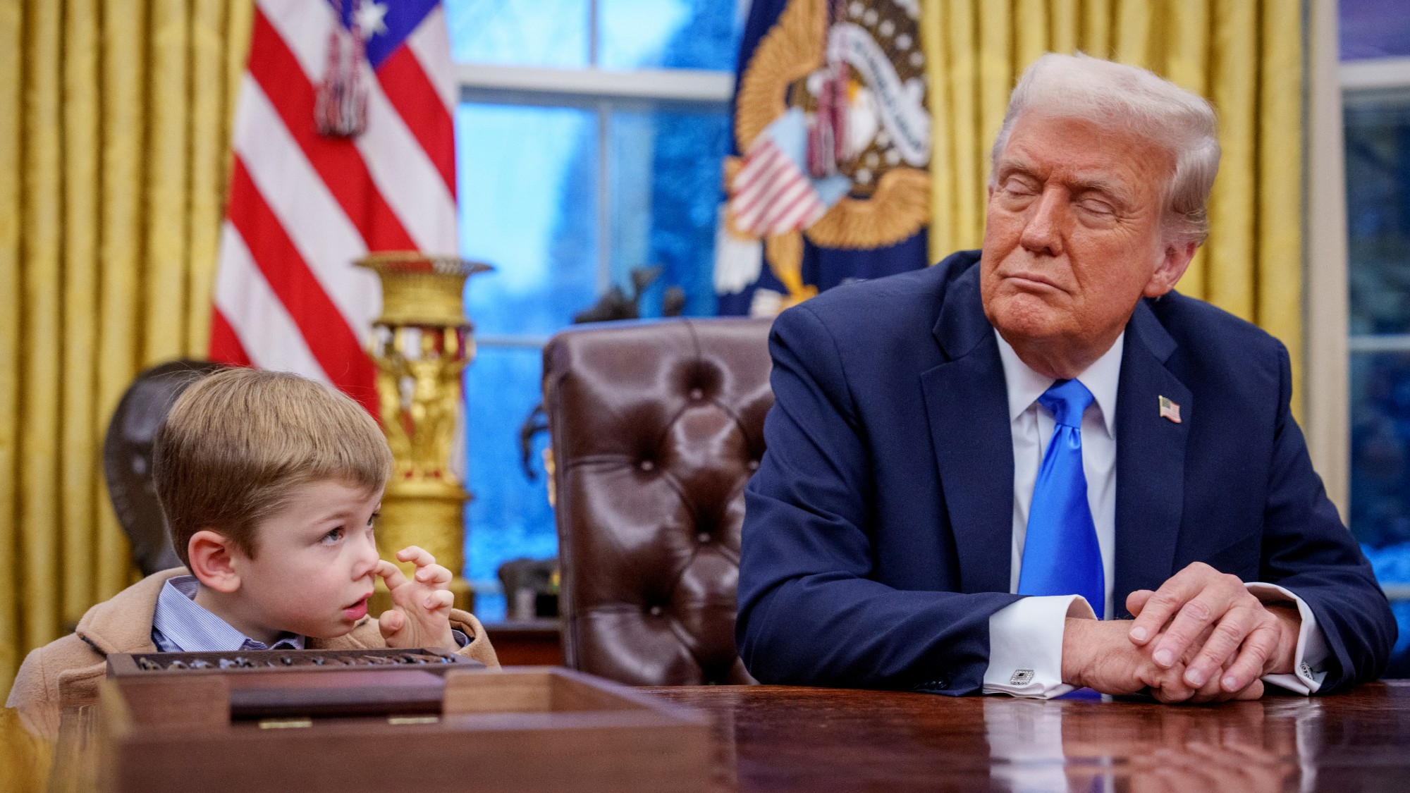 X Musk, the son of Tesla and SpaceX CEO Elon Musk, stands next to U.S. President Donald Trump during an executive order signing in the Oval Office at the White House