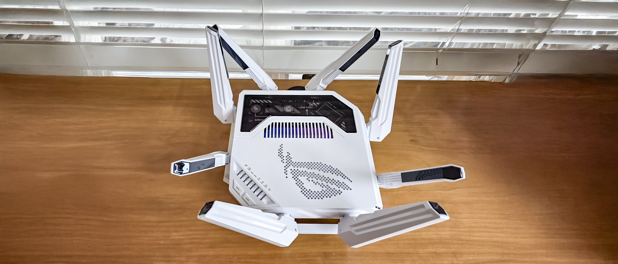 Asus ROG Rapture GT-BE19000AI router on a windowsill