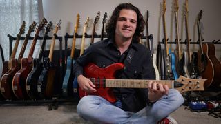 Fort Worth, Texas, USA. 27th Feb, 2024. Feb. 27, 2024. Grammy winning guitarist and composer Mark Lettieri with a red version of the "Fiore"" model Paul Reed Smith guitar he designed for the guitar company. Photographed in his home studio in Fort Worth, Tx.