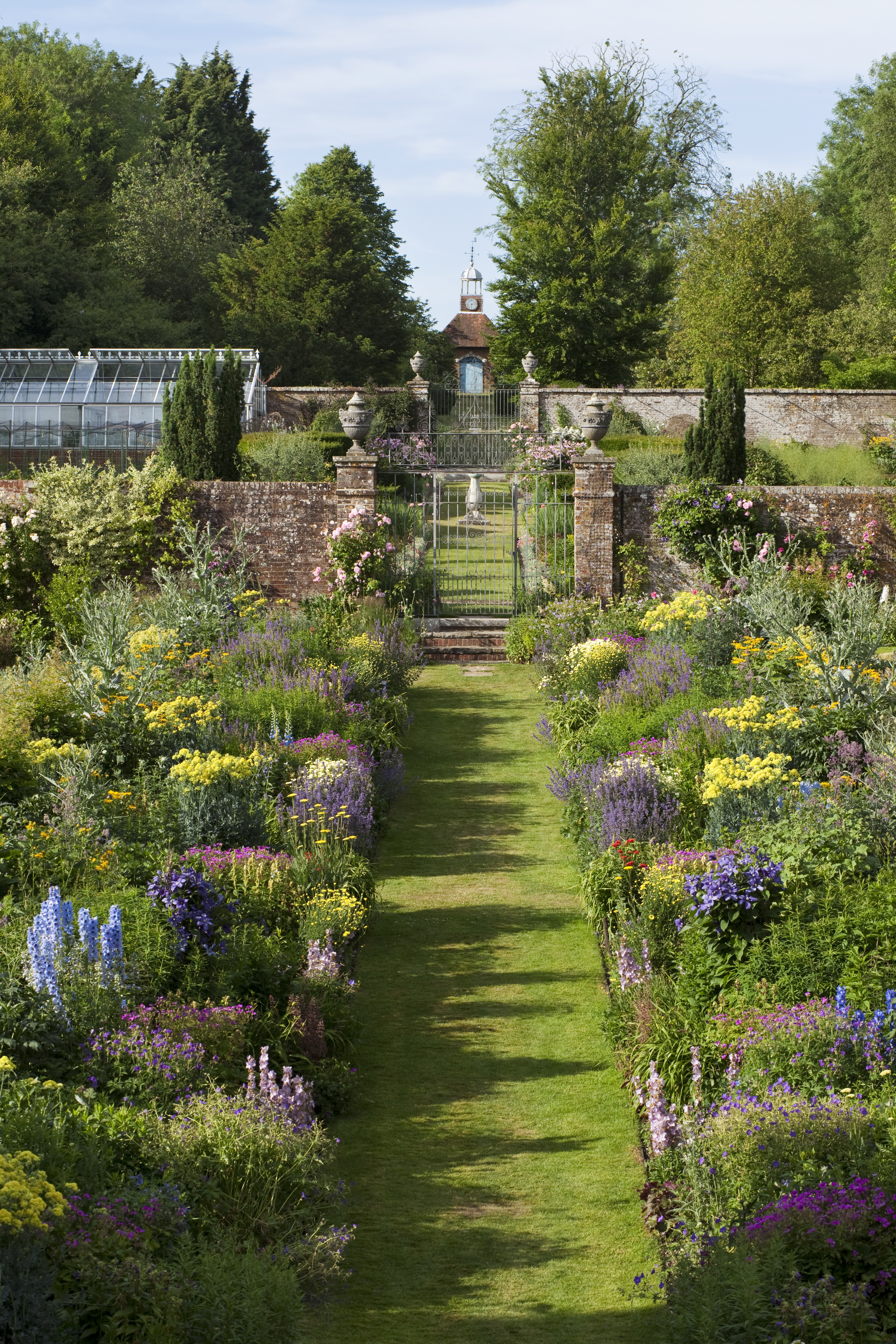 Looking down the mirrored herbaceous border in the gardens at Bramdean House
