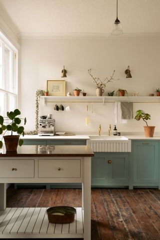 A two-toned kitchen by deVOL with pale blue-green cabinetry in Edwardian villa