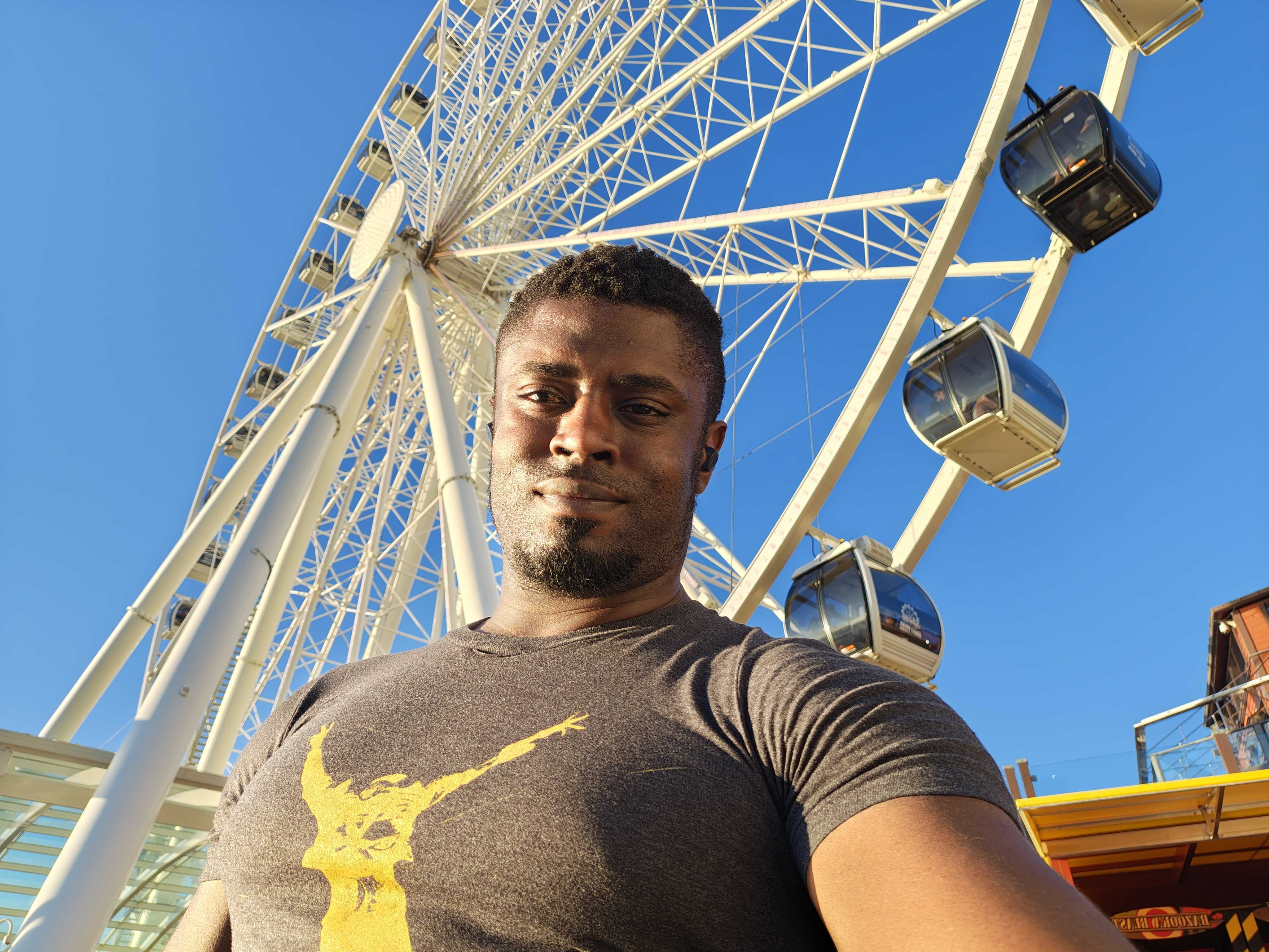 Taking a selfie in front of a ferris wheel