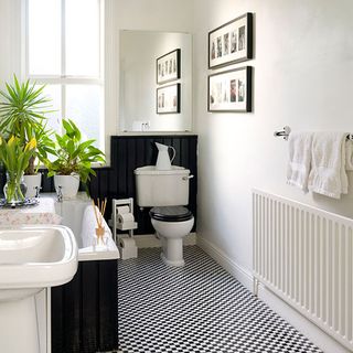 bathroom with black and white flooring and white wash basin