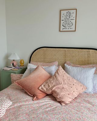Bed with pink throw pillows