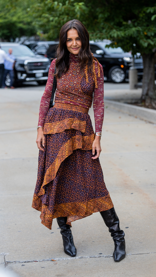 Katie Holmes wearing dress, black boots outside Ulla Johnson on September 11, 2022 in New York City