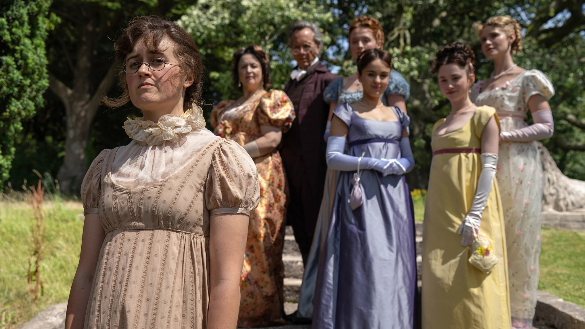 mary bennet stares off into the distance as her family watches behind her in a still from the other bennet sister