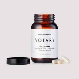 votary super sleep supplements in brown bottle against grey background
