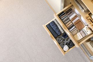 Neatly and tidy folded clothing in organizer drawer dividers