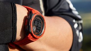 Man wearing Garmin Instinct Solar watch in red