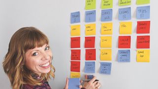 An image of UX expert Sophia V Prater – she is arranging coloured post-its and planning out object-oriented UX