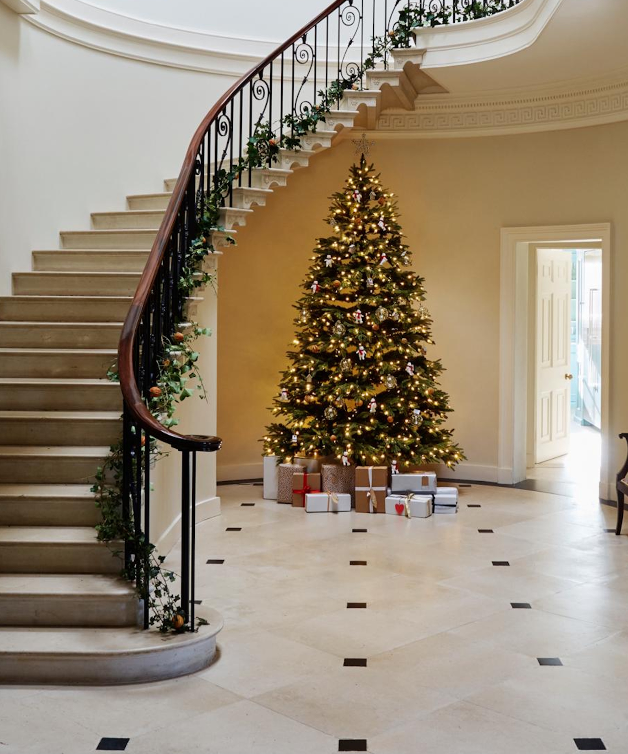 Christmas tree next to grand stairs