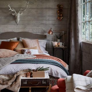Made up bed with blankets with wooden walls and sleigh