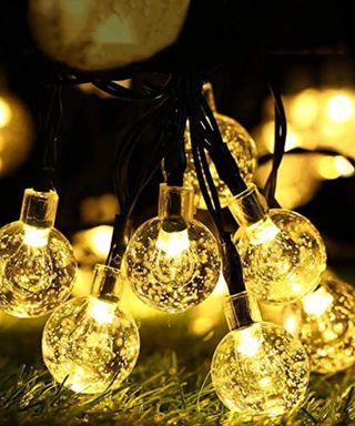 Amazon SOLAR CRYSTAL BALL STRING LIGHTS in yellow glow in cluster