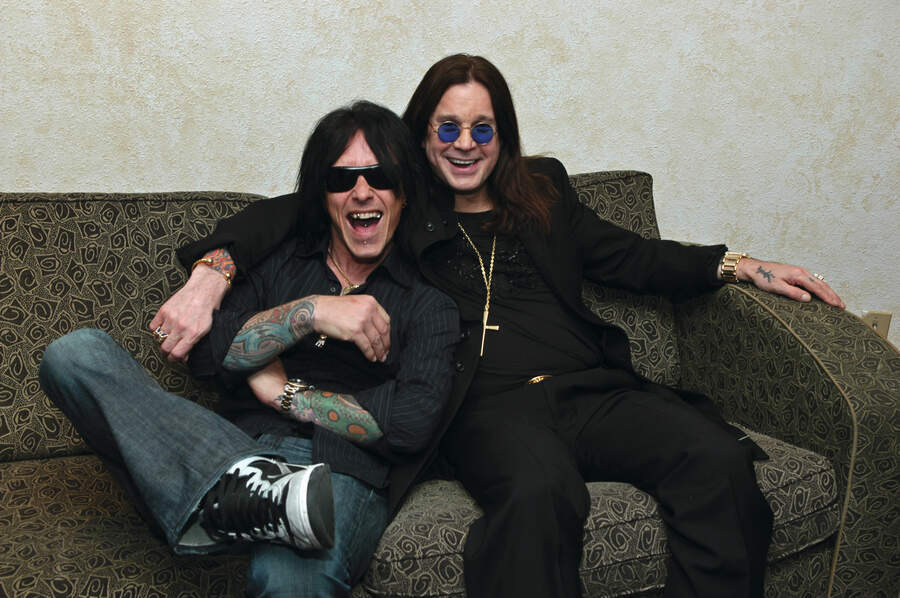 Billy Morrison and Ozzy Osbourne posed, sitting on sofa