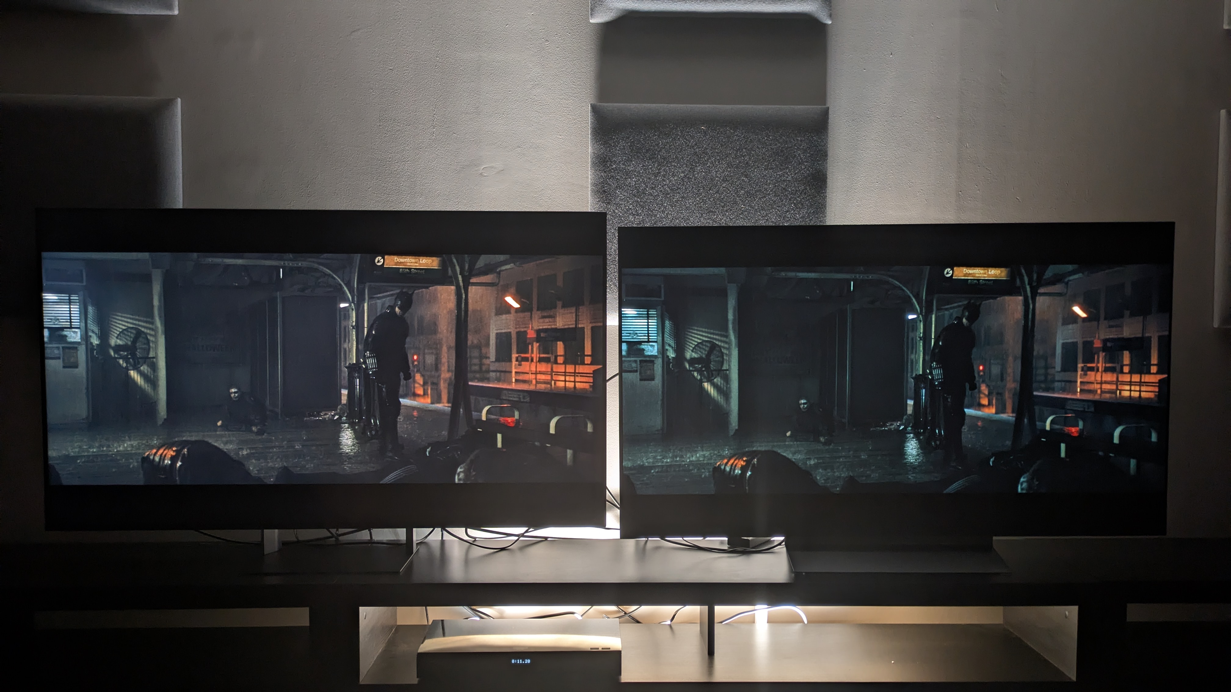Sony Bravia 7 II (left) vs LG C6 (right) showing Batman stood on subway platform from the batman. Both Tvs have good contrast, but the C6 has deeper blacks and the 7 II has better balance