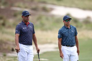 Rickie Fowler and Gary Woodland watch a putt