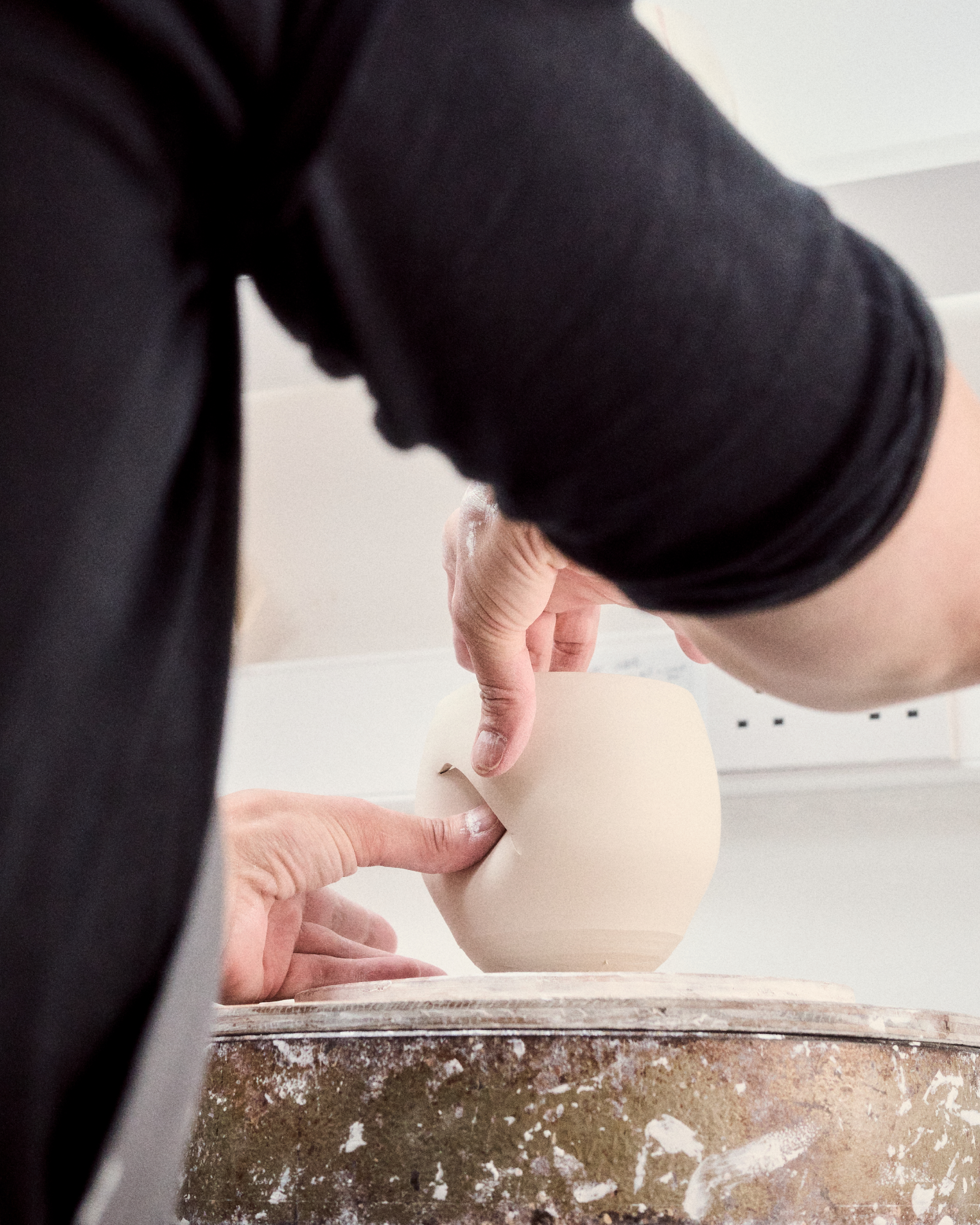 Candle by Tekla, with a vessel that looks like it was pinched on one side