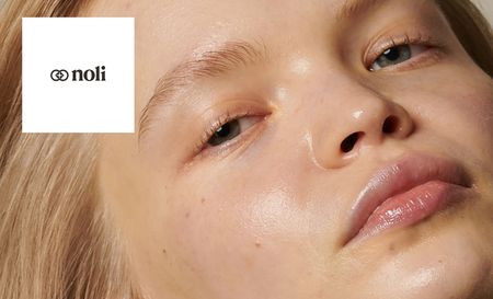 Noli logo top left with a close up shot of a womans face