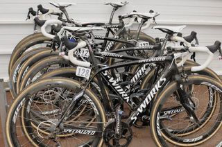 A pile of Saxo Bank Specialized Roubaix machines in need of a wash