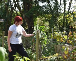 Kim adding comfrey to her garden