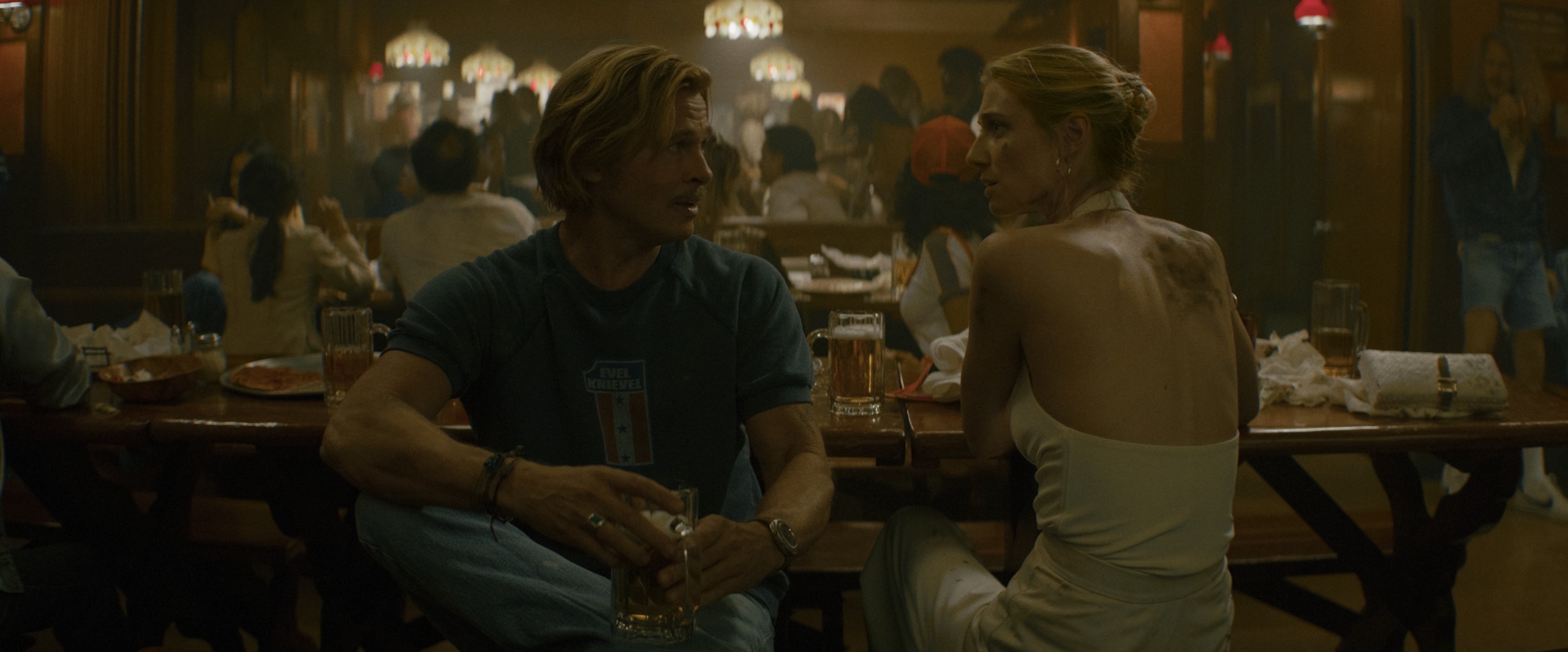 brad pitt as cliff booth and elizabeth debicki as karen crosby sitting at a 70s era bar in the further misadventures of cliff booth
