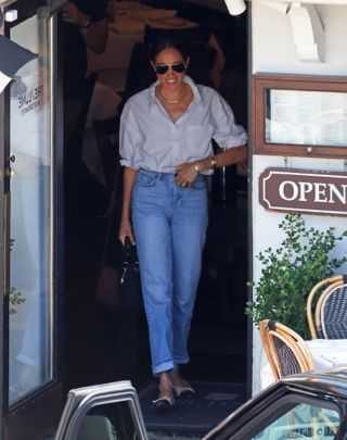 meghan markle leaves a montecito restaurant wearing an anine bing white button down and jeans with her princess diana lady dior bag