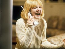 Drew Barrymore in Scream screams into a phone with a cute blonde short bob