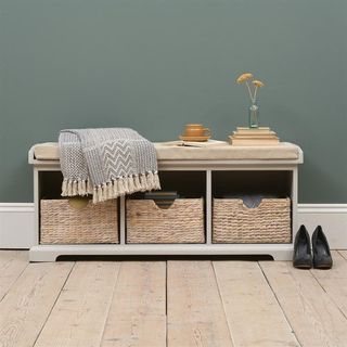 grey walled room with storage bench