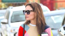 Katie Holmes in bright harlequin jumper and shades