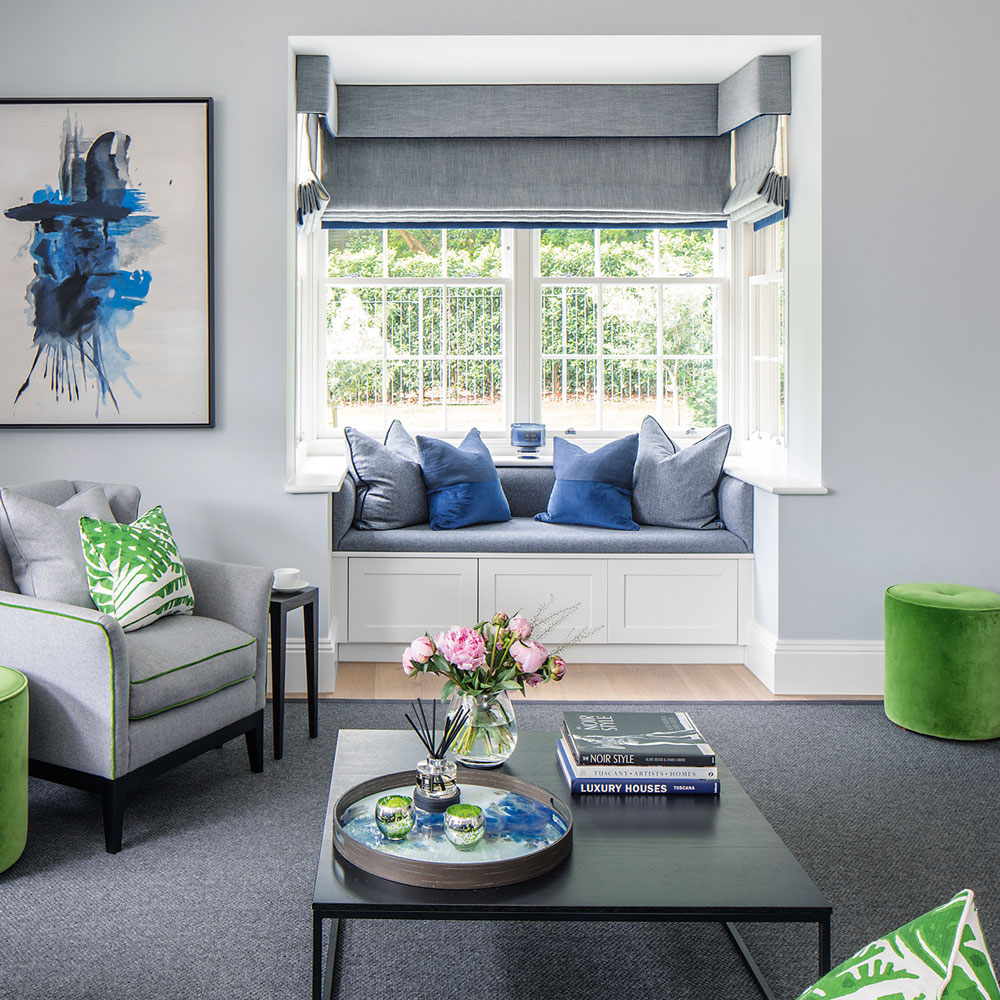 grey living room with small window seat bay window