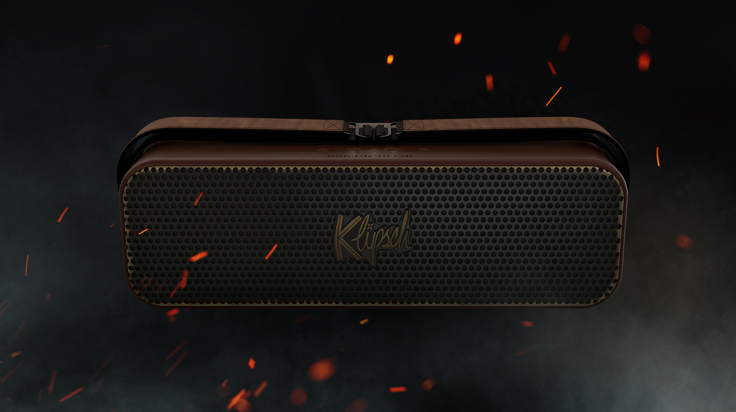 Front view of the Klipsch Detroit Odyssey on a black surface and background with embers in the air around it