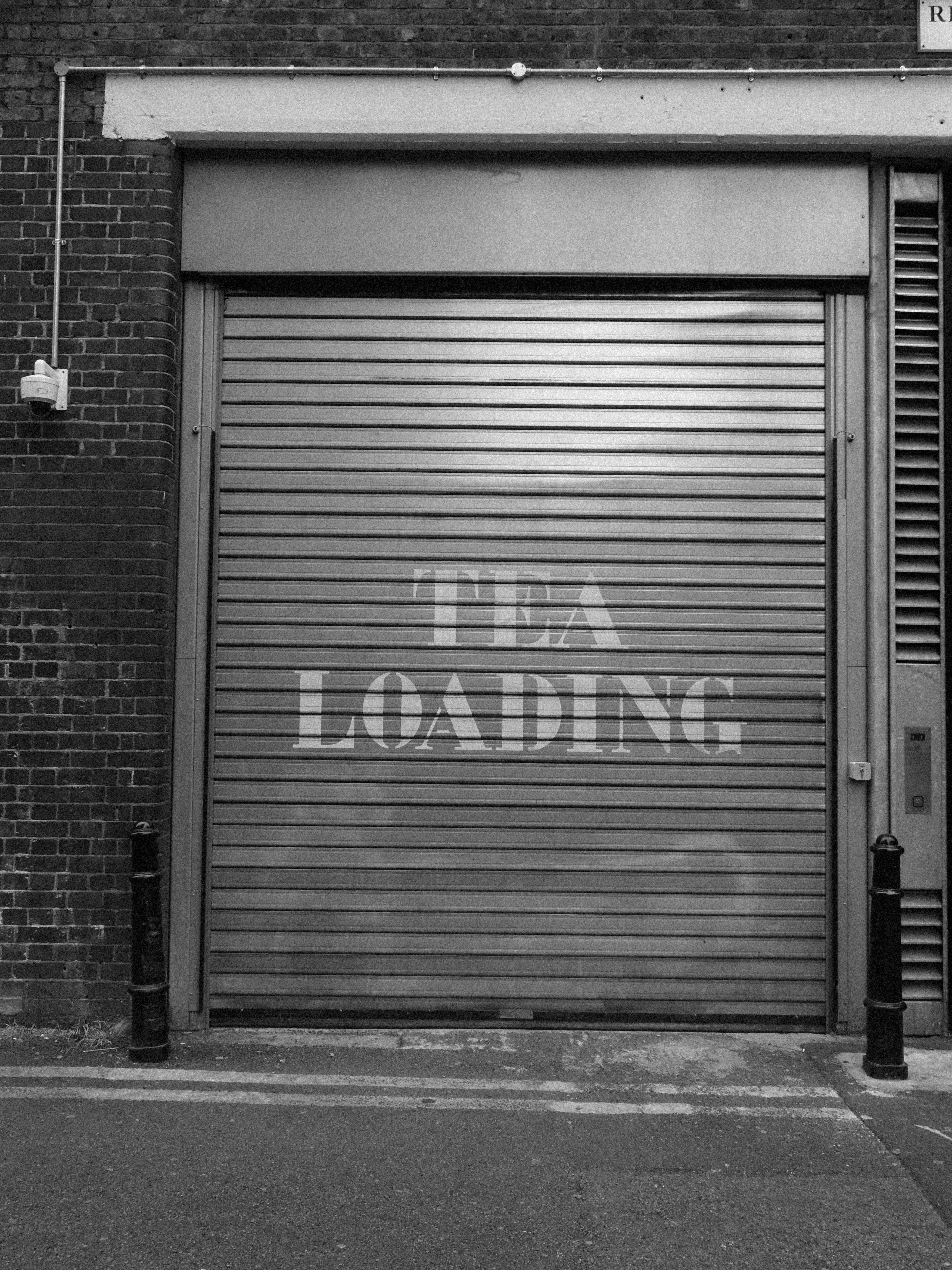 A metal shutter with text reading tea loading
