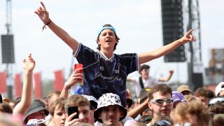 A crowd member raising the horns at Reading festival in 2025