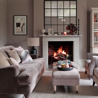 neutral living room with open fire place with large mirror above