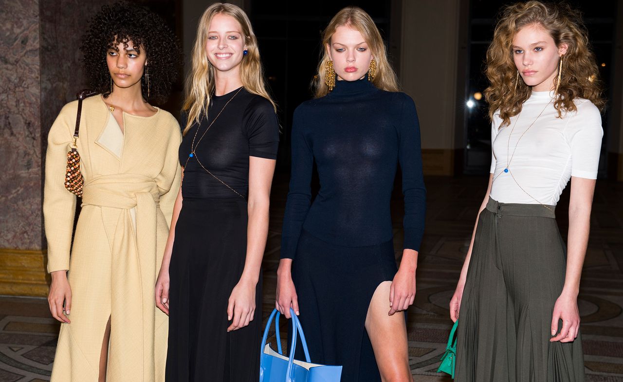 Model wears a yellow wrap jumpsuit, others wear cotton t-shirts and skirts with slits