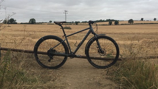 A Ribble Hybrid Trail AL picture in rural setting with field in background