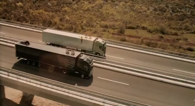 Faith Dickey slacklining between two semi-trucks on a Croatian highway.